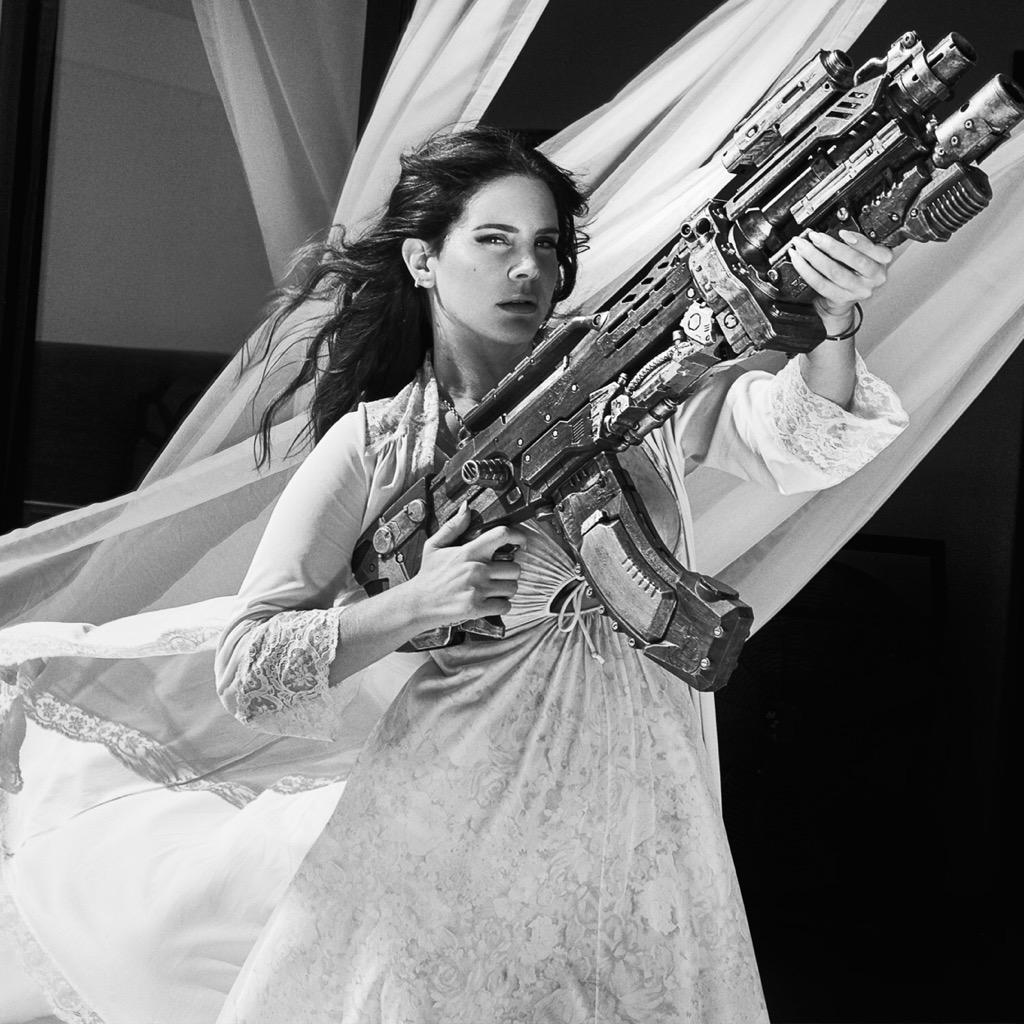 Lana Del Rey takes out a circling chopper with a big gun in her "High