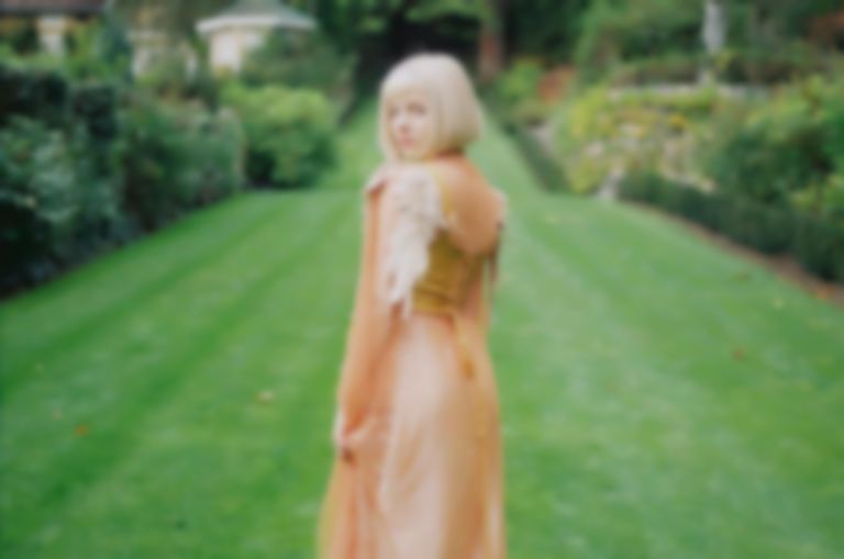 AURORA announces third album with new single “Giving In To The Love”