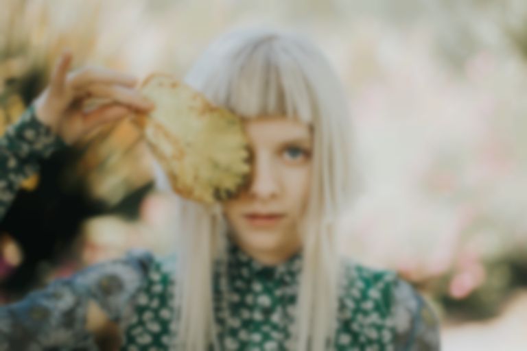 AURORA is releasing new track “Giving In To The Love” this week